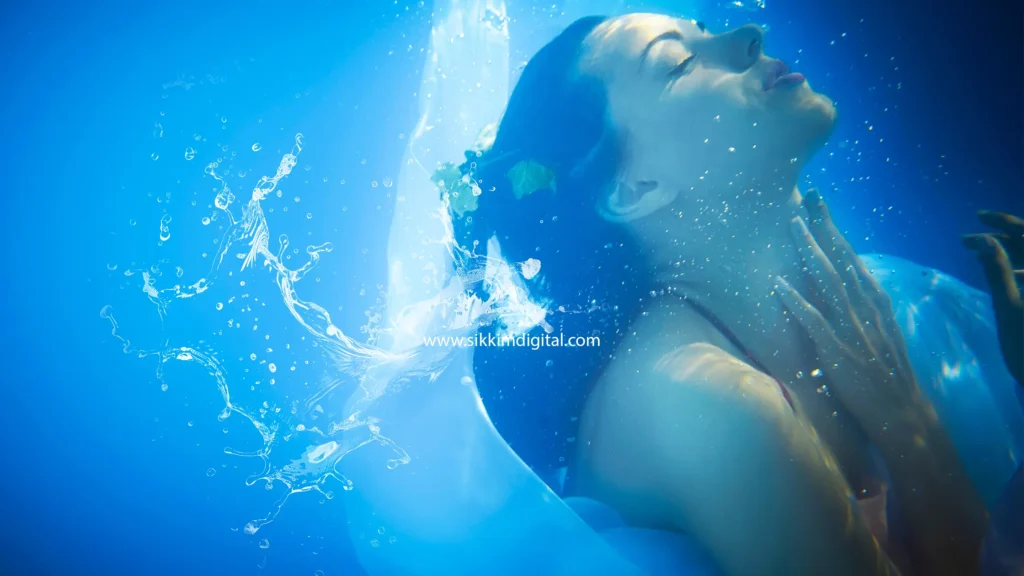 Woman peacefully submerged in clear blue water, with bubbles rising around her, symbolizing calmness, emotional clarity, and spiritual growth, representing the dream of seeing clear water in Eastern philosophy.