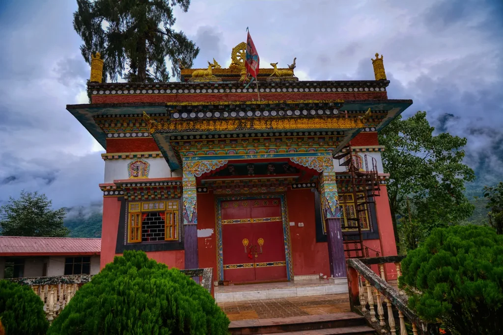 Kartok Monastery in Yuksom, West Sikkim, featuring ornate Tibetan Buddhist architecture with colorful painted walls, golden roof ornaments, and traditional decorative elements